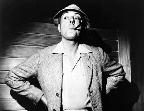 Jacques Tati as his character "M. Hulot." Note the enlarged nose at this camera angle. The large nose and nostril is a hallmark of some French cartooning.