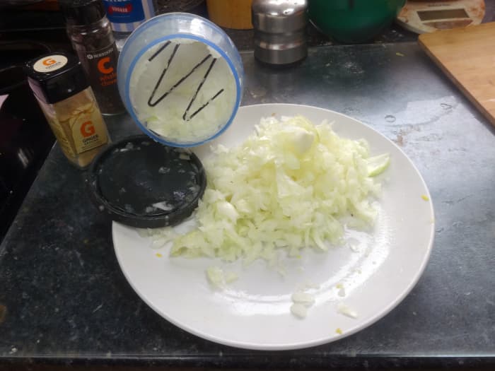Peel and cut each onion into eighths, placing four eighths into the chopper at a time, and bang down on the handle 50 times, to quickly finally chop the onions