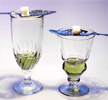 Glass of Absinthe 1914 Absinthe is served this way traditionally. It'€s not a unique configuration. The absinthe is poured through a sugar cube and slotted spoon into the glass. Incredibly alcoholic, it was banned the year after Picasso's work.