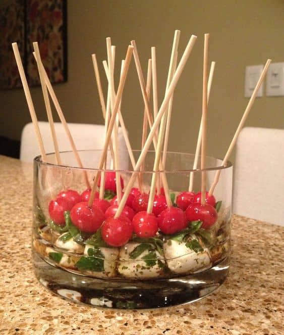 Delicious and eye catching this fresh appetizer never fails! Make sure to display it in a glass container to showcase it. Already marinated mozzarella balls makes this supper fast to prepare.