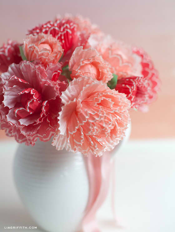 Lia Griffith creates peonies from cupcake wrappers. these delightful flowers could be created from any color wrapper. They can v=be used in a garland, a wreath or as a cemterpiece