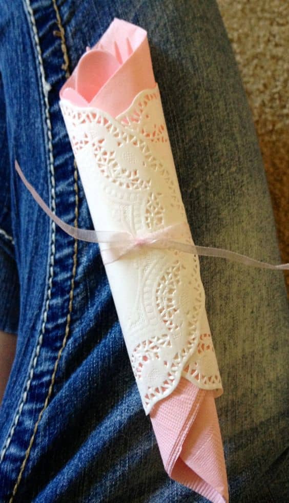 Wrap your silverwear is a napkin and wrap a napkin and then a doily around it. Tie with twine or a piece of ribbon.