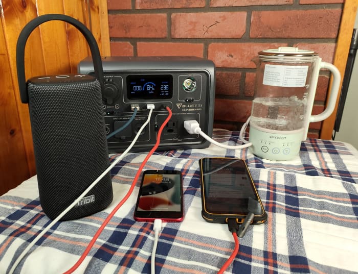 This station is simultaneously boiling water and charging two phones and a Bluetooth speaker 