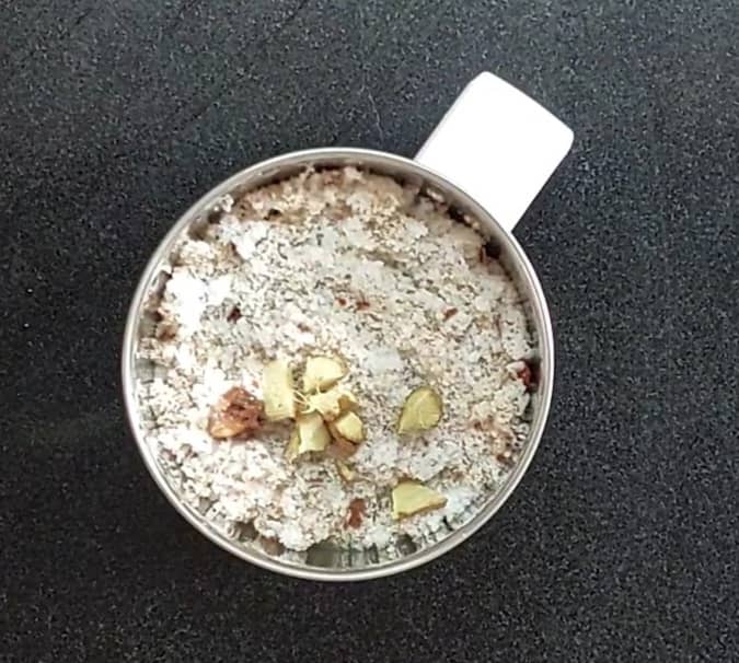 Transfer the fried ingredients to a mixer jar. Add 1 cup grated coconut, 1/2 teaspoon tamarind, 1 teaspoon chopped ginger and 1/2 cup water.