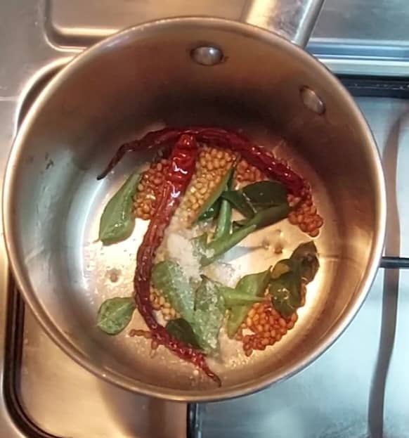 Add a sprig of curry leaves and 1/4 teaspoon hing (asafoetida). Saute till urad dal turns light brown and aromatic. Do not burn the urad dal. Transfer to a plate.