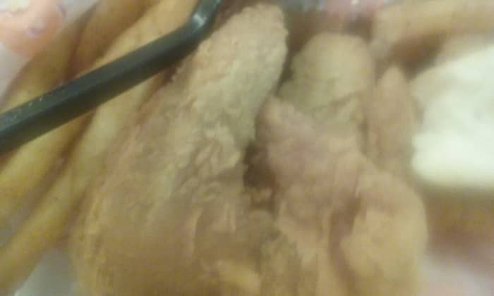 Delicious, hot, golden and crispy fried chicken served at Popeye's Louisiana Chicken fast food restaurant.
