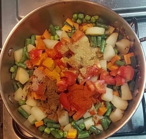 Add 1/2 teaspoon turmeric powder, 1 teaspoon red chili powder, 1 teaspoon coriander powder, 1/2 teaspoon cumin powder, 1/4 teaspoon dry mango powder, 1/2 teaspoon garam masala powder.