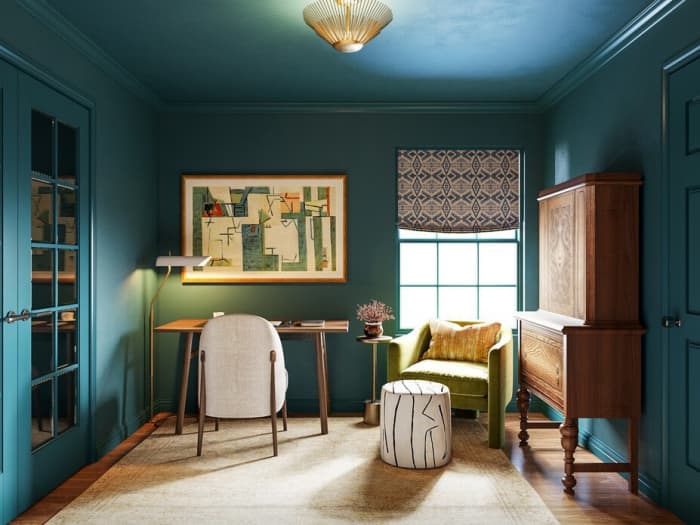 An office with vivid paint color. The room is outfitted with furniture in different yet complementary styles.