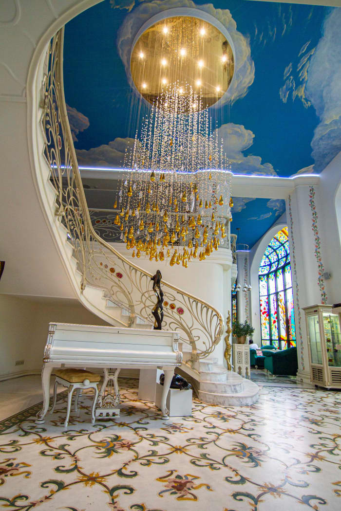 Art Nouveau is making a comeback for its focus on forms related to plants and flowers. The floor of this elaborate room plays off the Art Nouveau style. The staircase and chandelier have shapes related to the design movement.