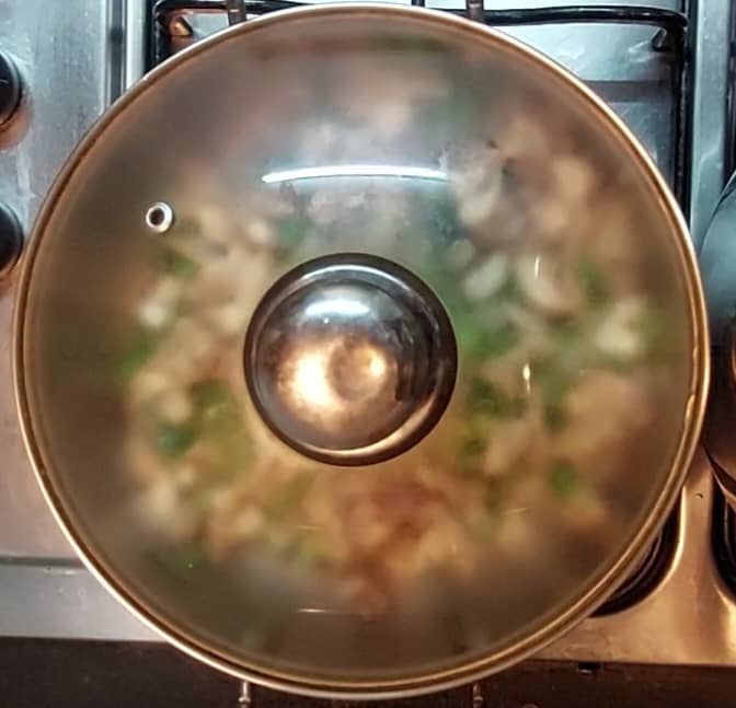 Mix well. Close the lid and cook in medium flame. No need to add water as mushroom leaves lots of water while cooking, which is enough to cook them.
