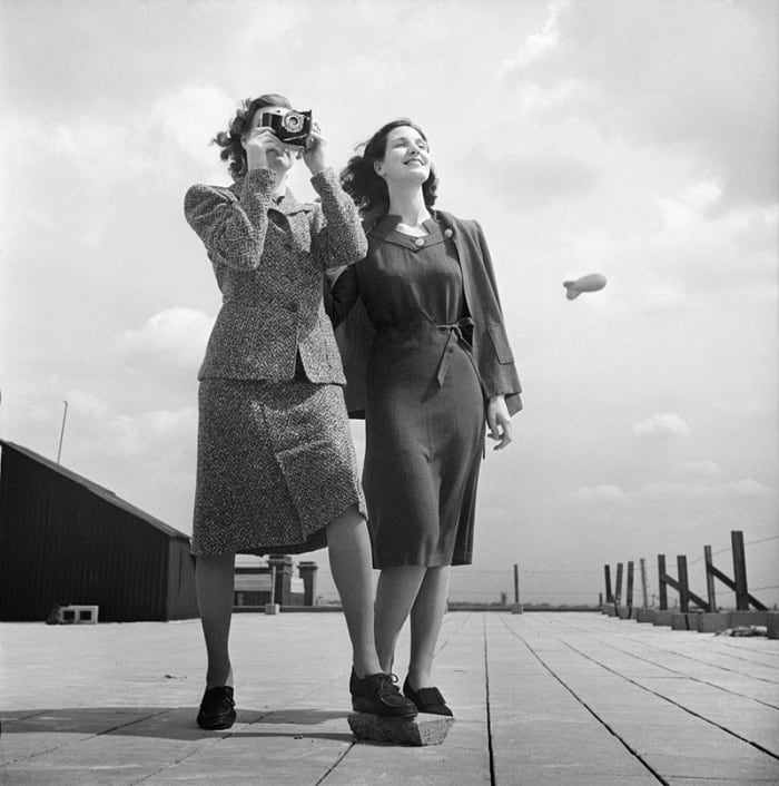 Shorter hemlines, simple lines, and longer hair typified women's fashions in this image from 1943.