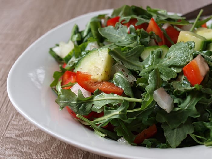 My favorite salad, with only 77 calories, includes arugula, cucumber, red pepper, grape tomatoes, sweet onion, and lemon-garlic vinaigrette.