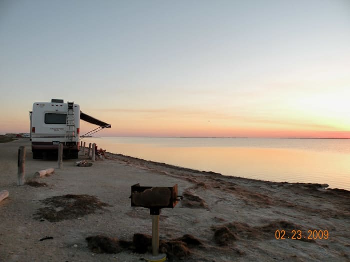 Campsite at Bird Basin, Padre Island National Seashore with a serene view of the sunset on Laguna Madre.