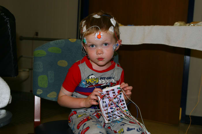 Sleep studies require a lot of sensors and wires. In this photo, our son has about half the required sensors attached.