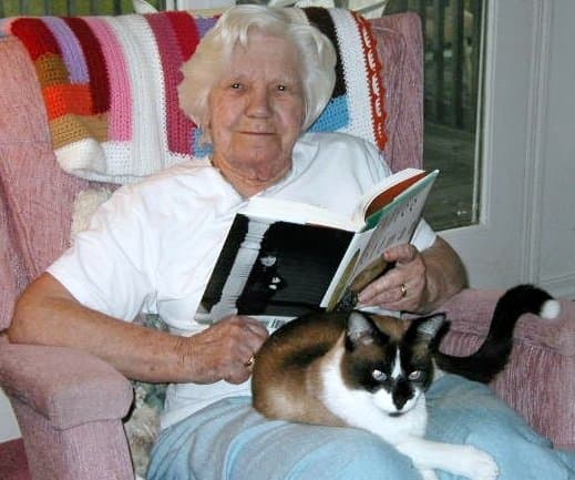 My Mom enjoying some of the comforts of old age...a good book, a comfortable place to read it and a warm cat purring on her lap...