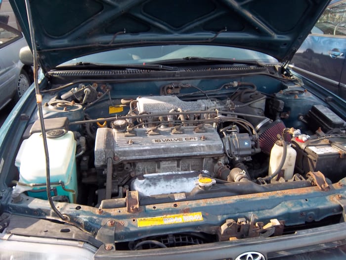 The engine bay of a 1994 Toyota Corolla. Regular oil changes are vital to ensuring your car's life and continued smooth performance.