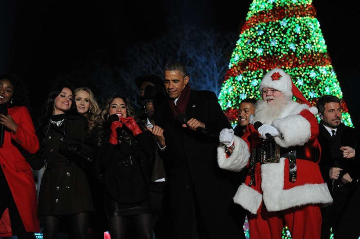 Former President Barack Obama dances with Santa Claus on December 4, 2014.