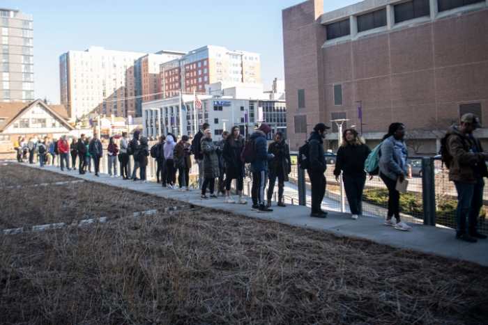 Hundreds of students and residents wait in line to register and to vote outside of Ann Arbor City Hall Tuesday afternoon.