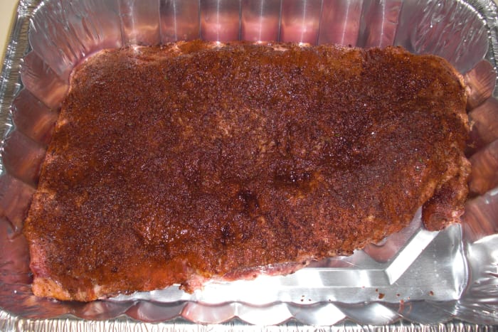 This is the uncooked brisket with my wet/dry rub seasonings on it and ready to marinate.