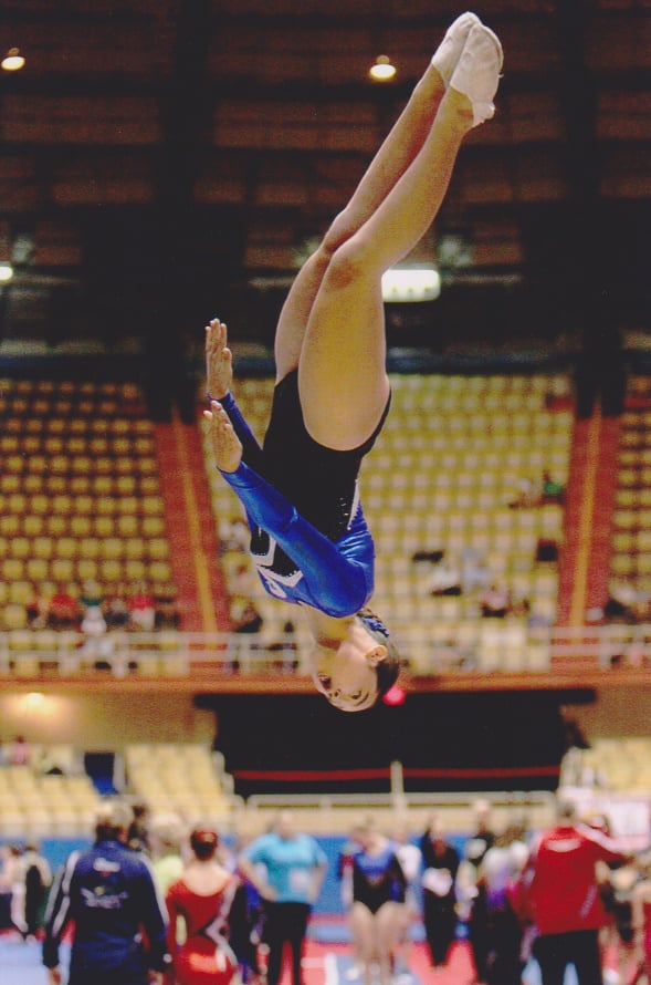 My own daughter competing at the USAG Junior Olympic Trampoline &Tumbling National Championships. She is completing a half twist (barani) in the air during her double mini trampoline dismount.