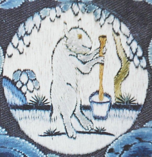 A medallion on an 18th century Chinese emperor's robe depicting the Moon Rabbit mixing its elixir of life at the foot of a cassia tree.