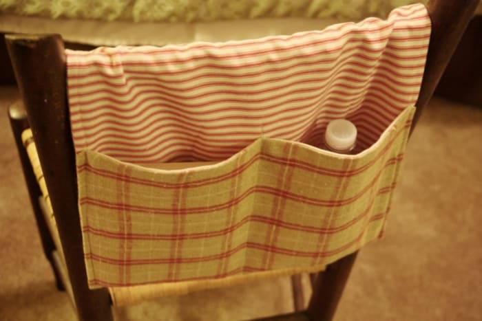 Here is the finished walker tote, hanging over a chair as it would hang over the bar of a walker.