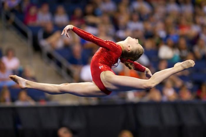 Madison Desch started her gymnastics career as a gymnast with me! Madison is performing a switch-ring leap.