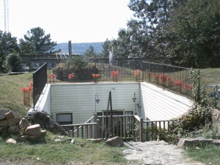 The front entrance to our underground home—an atrium that is accessible by a double staircase, one of stone and the other of wood.