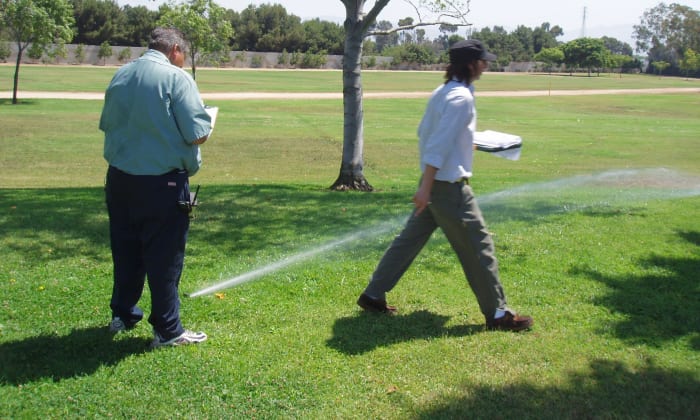 Conducting an irrigation audit includes checking each sprinkler to make sure it's spraying properly, then taking notes on what needs to be corrected.