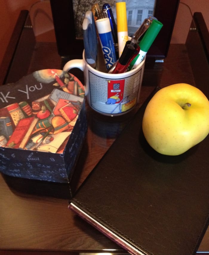 Tools of the trade: handy desk mug filled with pens, pencils, hole-punch, scissors, and markers.