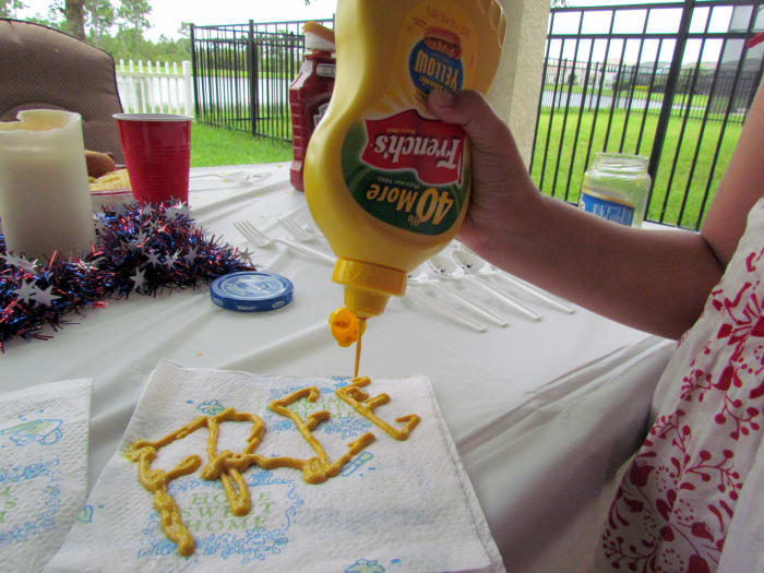 Thomas Jefferson as Mustard, writing the Declaration of Independence. If you have the big fancy napkin, because you wanted to impress your family and friends this holiday with your tableware, you can write the whole word, "FREEDOM."