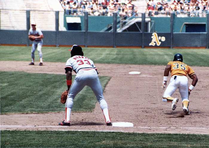 Rickey Henderson takes off for second base as Eddie Murray covers first. Note Cal Ripken at shortstop in the background. All three are in baseball's Hall of Fame.