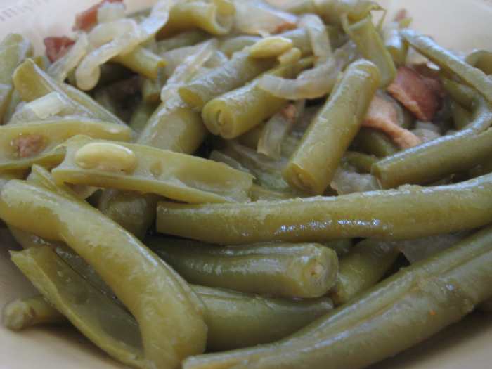 Paula Deen's delicious green beans are seasoned with chicken broth, bacon or salt pork, and onions.