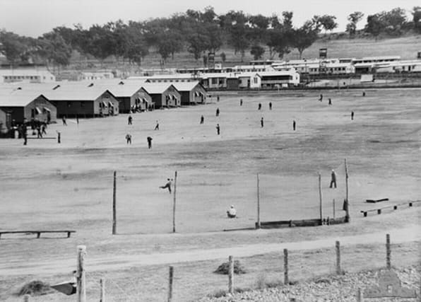 WW2: No. 12 Prisoner of War Camp, Cowra, Australia. 1 July, 1944. Japanese prisoners of war practice baseball on the sportsground near their quarters, several weeks before the Cowra breakout.