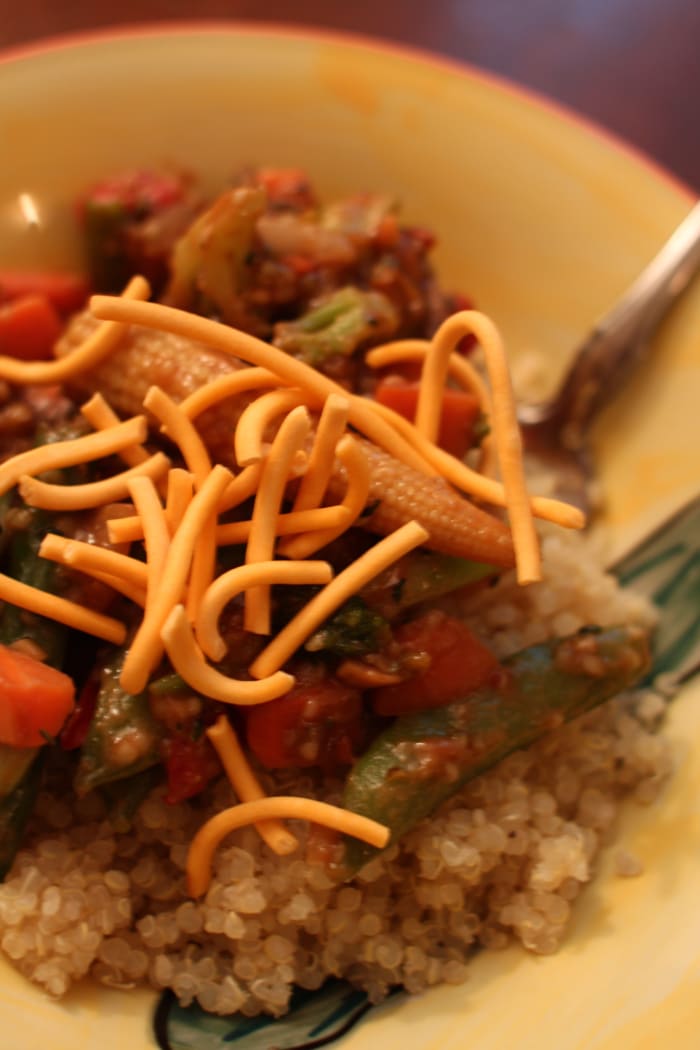 Becoming a veg-head can be as easy as making this delish dish out of some quinoa, frozen veggies, peanut sauce, and chow mein noodles.