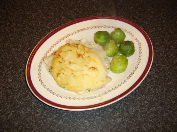 Traditional British fish pie is a meal in itself so is usually served only with one or two small vegetable accompaniments
