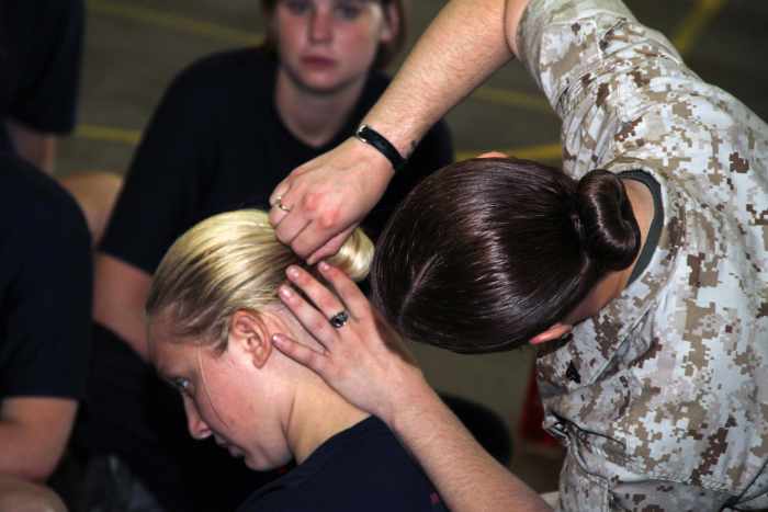 Learn how to make a sock bun, which is a female hairstyle that meets military regulations.