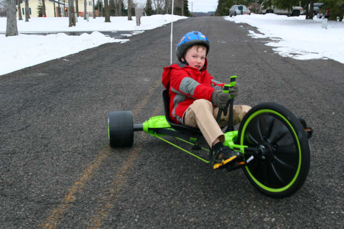 The author's tall 7-year-old son rides his new Huffy Green Machine on Christmas Day.