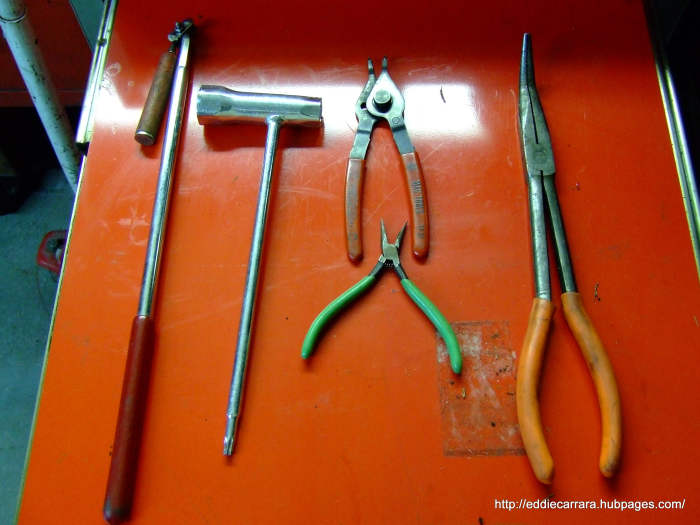 Magnet, snap ring pliers, large and small needle-nose pliers, and a Stihl torx/plug socket.