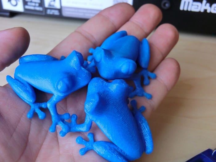 These frogs were printed with a different layer thickness of melted and then solidified plastic. Thinner layers produce a smoother appearance.
