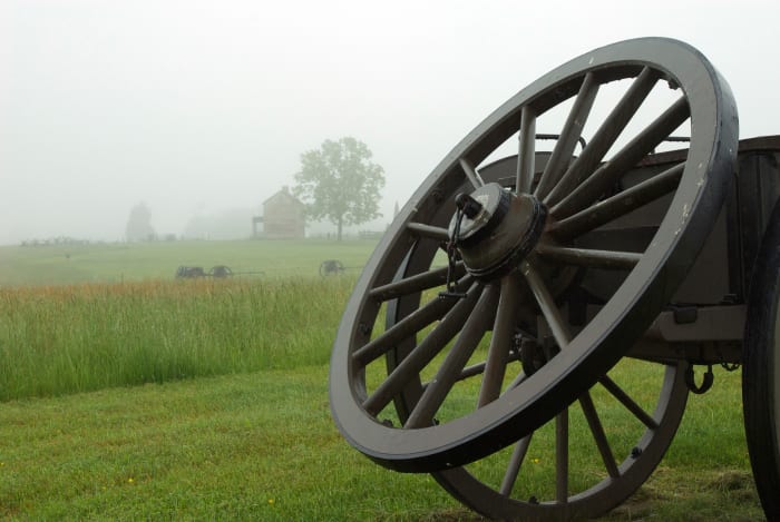 Near the main entrance are a series of cannons and wagons. The old house in the background is an important feature in the movie they play inside. If you look closely, you can see it in the foggy distance.