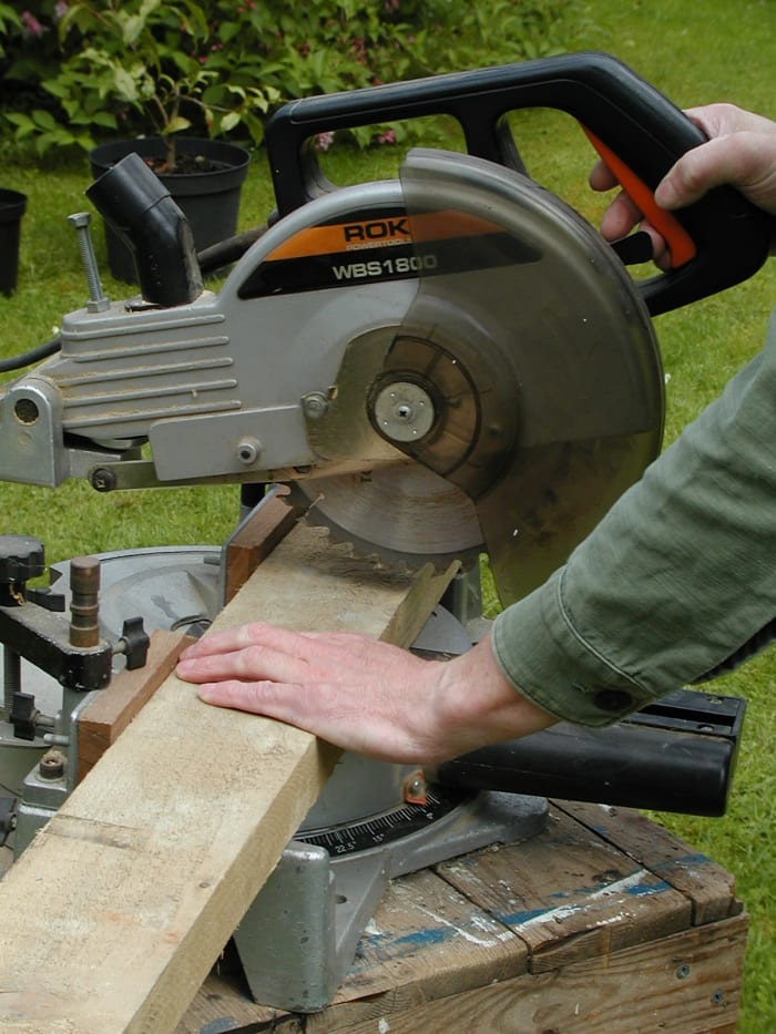 Cutting with a miter saw. The guard retracts when cutting and should return when you raise the cutting head
