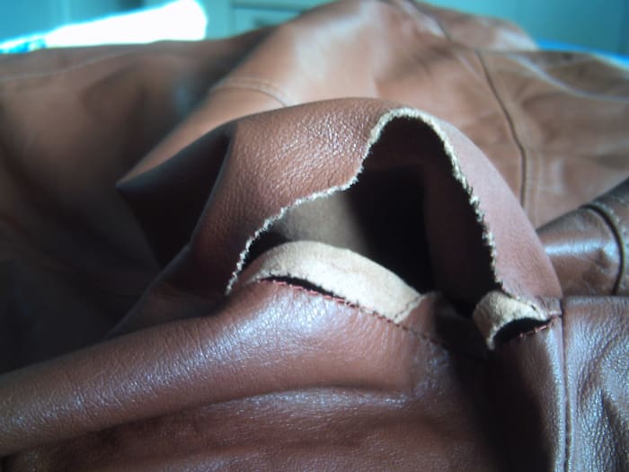 Large leather tear in loose leather is very hard to sew, and can be just as tricky to resew as leather that is too tight