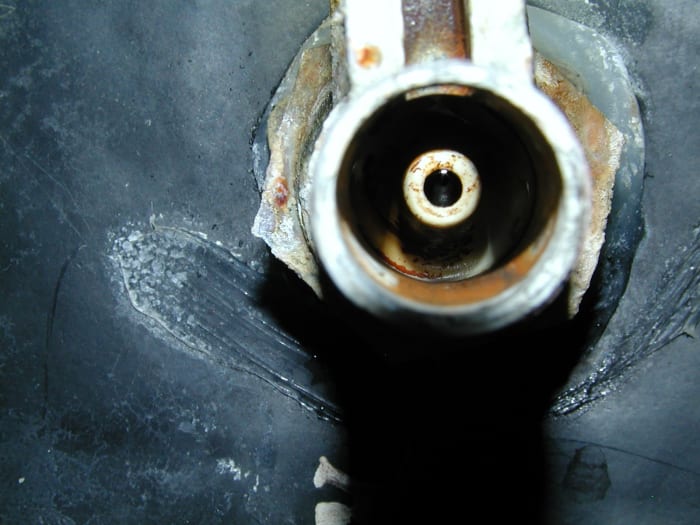 Water comes out through this nipple. Eventually over a period of decades, grooves can form at the end and the rubber washer at the end of the slider won't seal properly. So the complete ballcock valve will have to be replaced