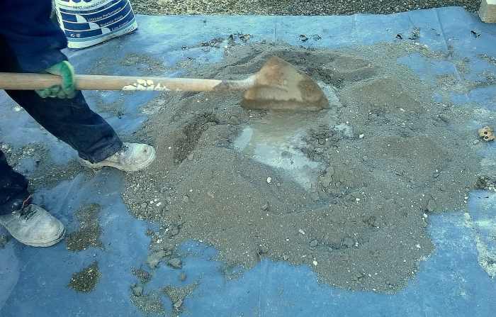 "Chop" the pile with the edge of the shovel to help distribute the water. Continue to add water