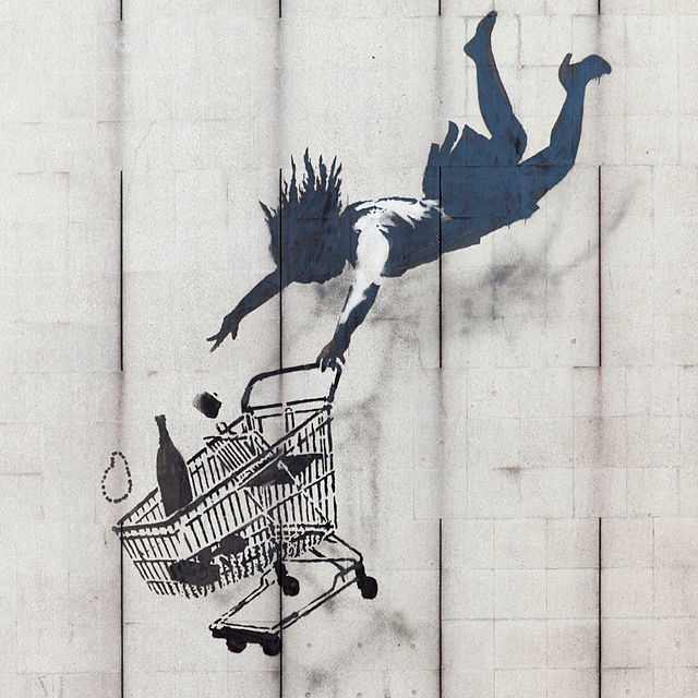 Shop Until You Drop by Banksy. This mural is in Mayfair, London. Beginning in Bristol, England, Banksy's work can now be found across many cities in the UK and around the world.