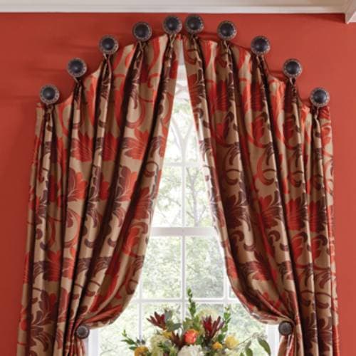You can purchase medallions or use cheap cabinet pulls or vintage door knobs for hanging curtains along the curve.