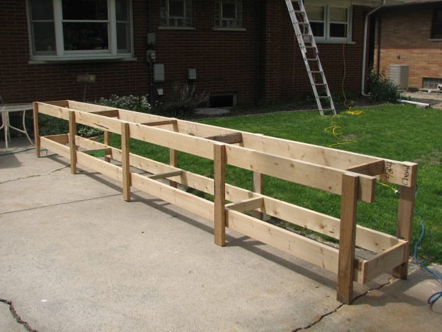 Adding legs to the crate boards while they were still banded together made the frame for a perfect workbench for the long steel roofing panels
