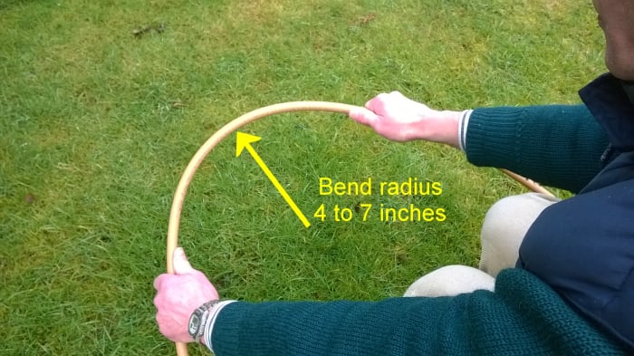 1/2 inch PEX tube can be bent to a min radius of 4 inches (depending on wall thickness).
