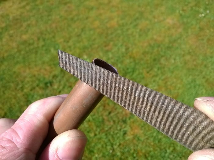 Use a file or de-burring tool to remove any sharp edges if you cut pipe with a hacksaw.